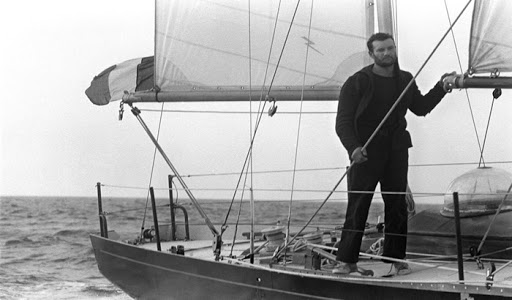 French sailor Eric Tabarly crosses the finish line aboard Pen Duick II in Newport, Rhode Island, 18 June 1964 to win the transatlantic race betwen Plymouth and Newport.